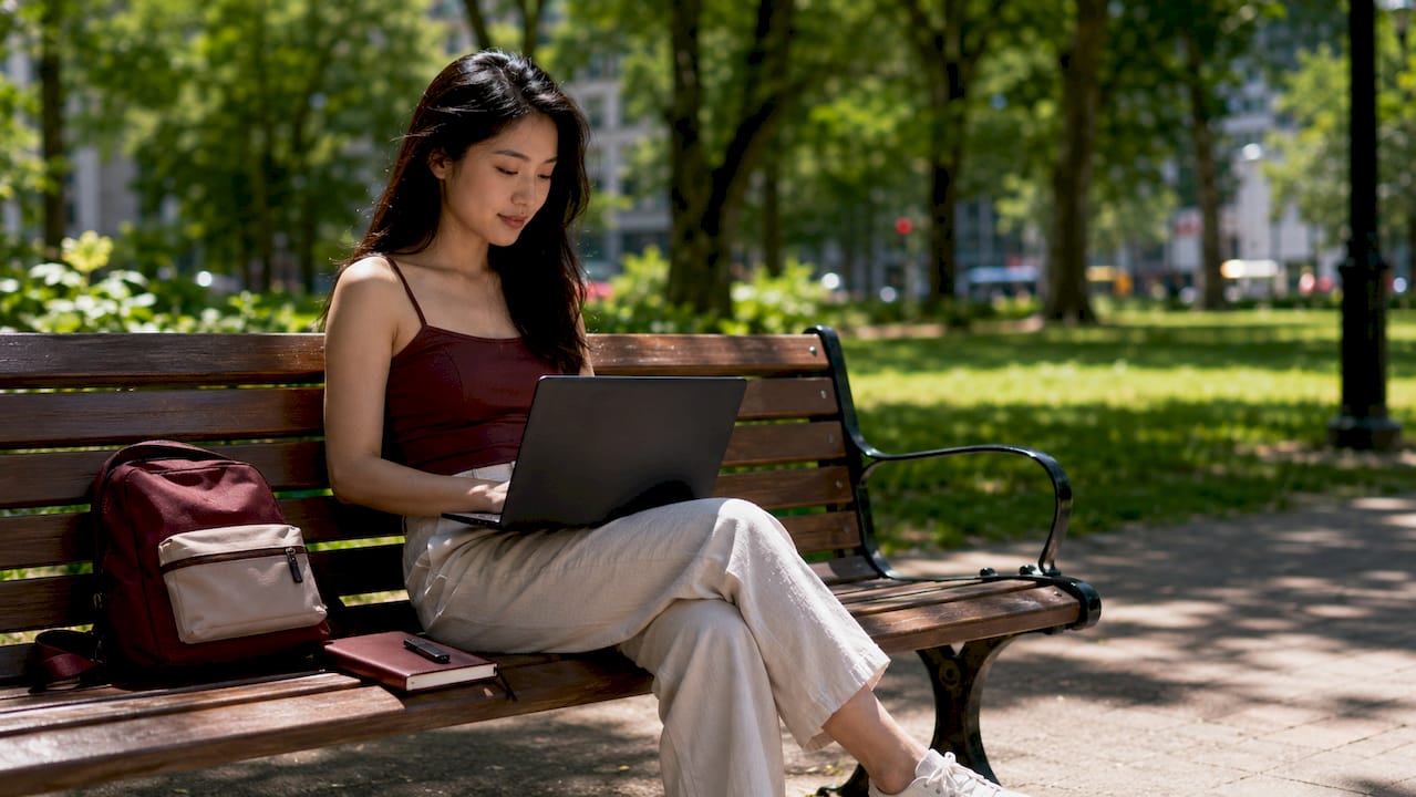 Digital nomad woman working securely at outdoor café