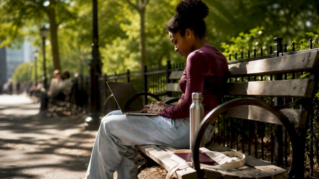 Woman working on laptop in café with privacy seating